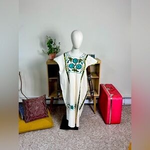 Embrace the timeless elegance of the 1970s with this vintage knit poncho coverup